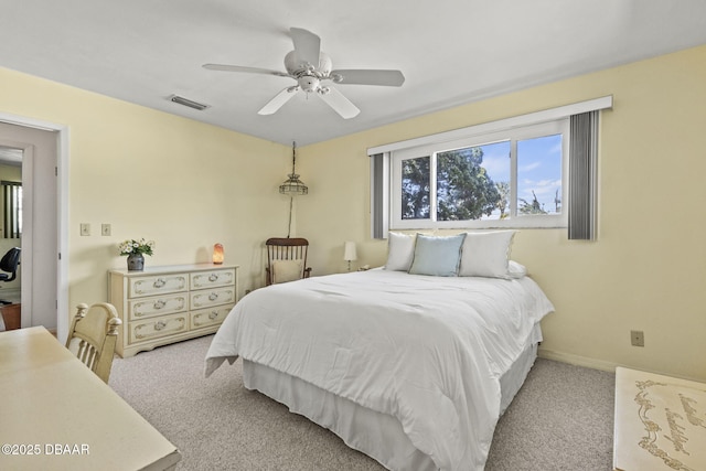 bedroom featuring visible vents, a ceiling fan, baseboards, and carpet floors