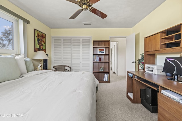 bedroom featuring visible vents, light colored carpet, a closet, and a ceiling fan