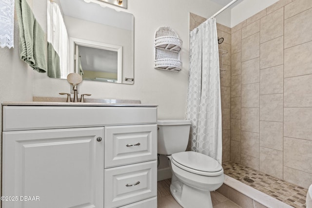 full bath featuring a stall shower, toilet, and vanity