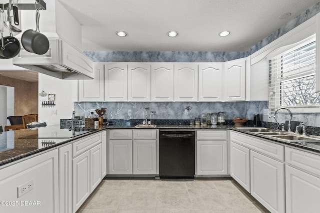 kitchen featuring a sink, backsplash, black appliances, and white cabinetry