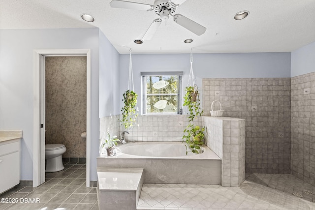 full bath featuring a bath, ceiling fan, a textured ceiling, tile patterned floors, and toilet