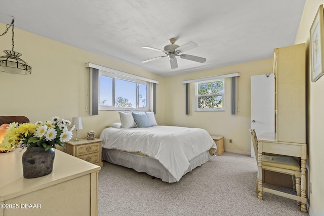 bedroom with baseboards, light carpet, and ceiling fan