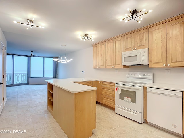 1133 Ocean Shore Blvd Unit 202, Ormond Beach, FL 32176 - kitchen with light brown cabinetry, a chandelier, white appliances, and light countertops