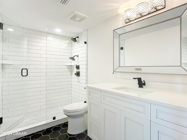 bathroom featuring tile patterned flooring, vanity, toilet, and an enclosed shower