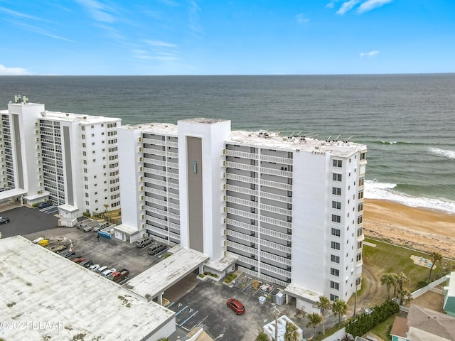 bird's eye view featuring a water view and a beach view