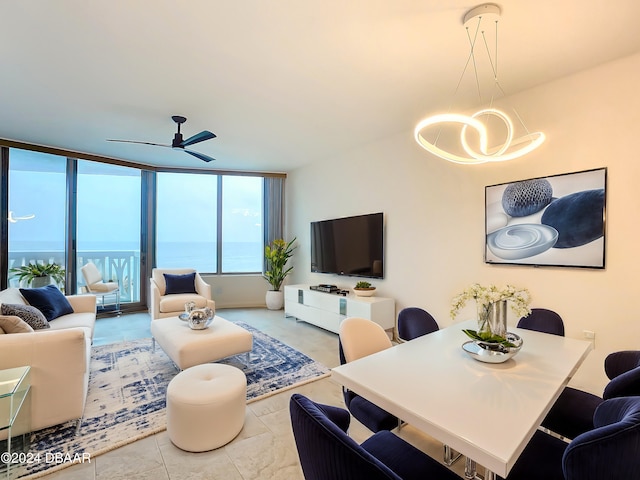 living room with floor to ceiling windows and ceiling fan