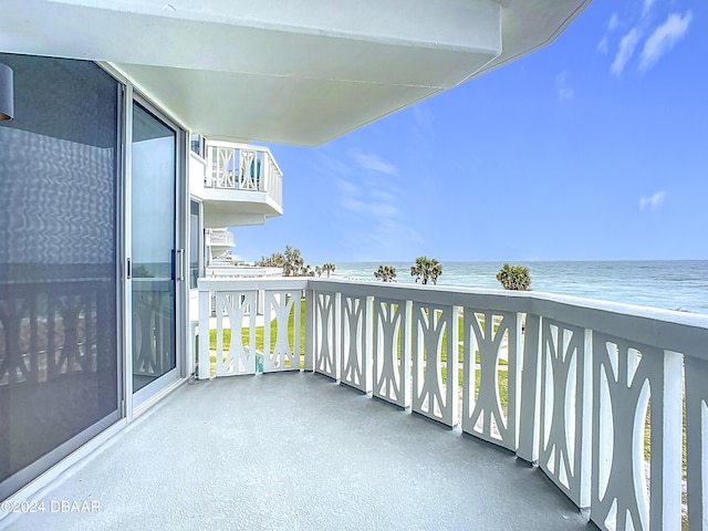 balcony with a water view and a beach view