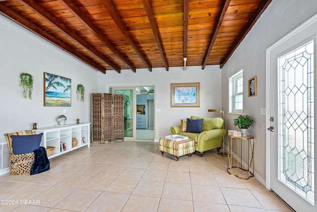 living area with beam ceiling, wood ceiling, and light tile patterned floors