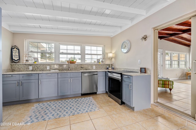 kitchen with sink, wooden ceiling, lofted ceiling with beams, light tile patterned floors, and appliances with stainless steel finishes