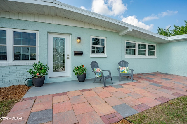 doorway to property featuring a patio area