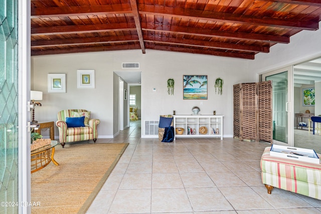 living room with vaulted ceiling with beams, wood ceiling, and light tile patterned flooring