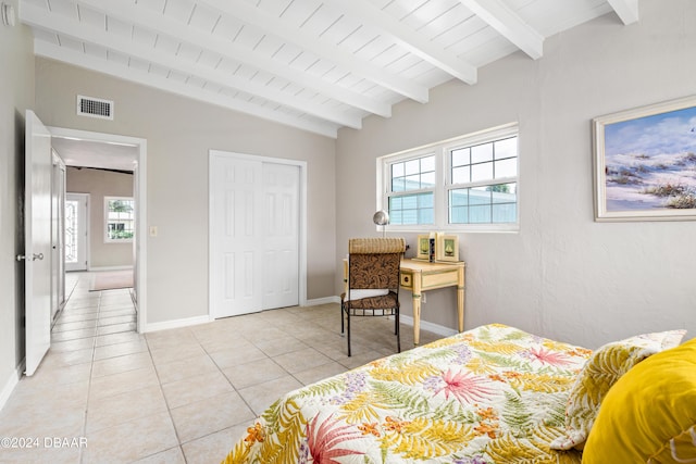 tiled bedroom with lofted ceiling with beams, wooden ceiling, and multiple windows