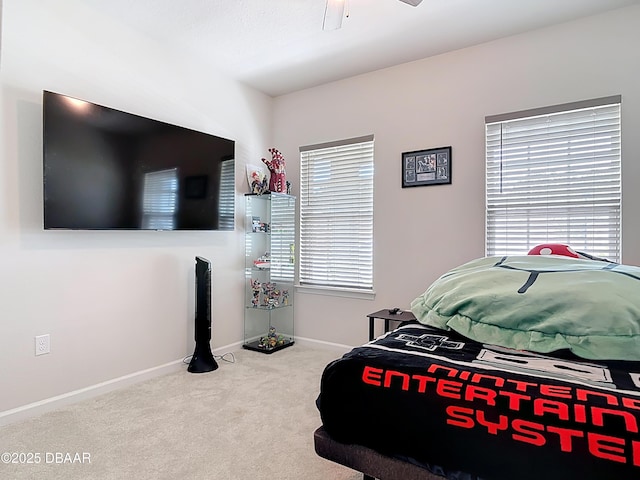 bedroom with ceiling fan, baseboards, and carpet floors