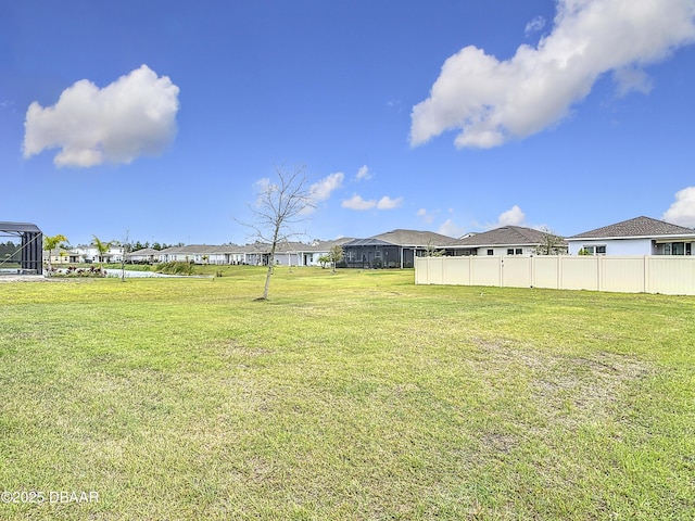 view of yard featuring a residential view and fence