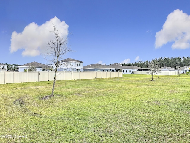 view of yard featuring a residential view and fence