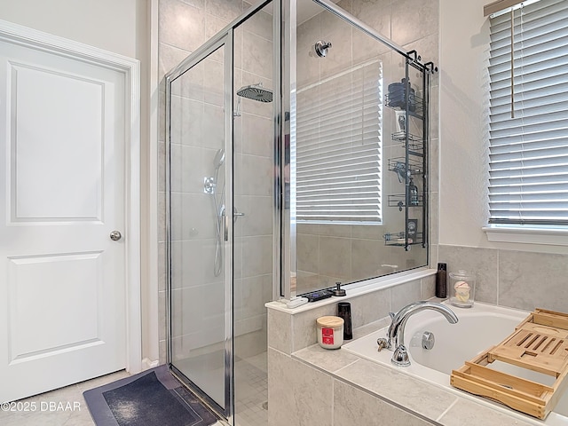 full bathroom featuring a bath and a stall shower