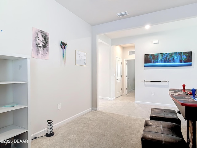 living room with visible vents, baseboards, and light colored carpet