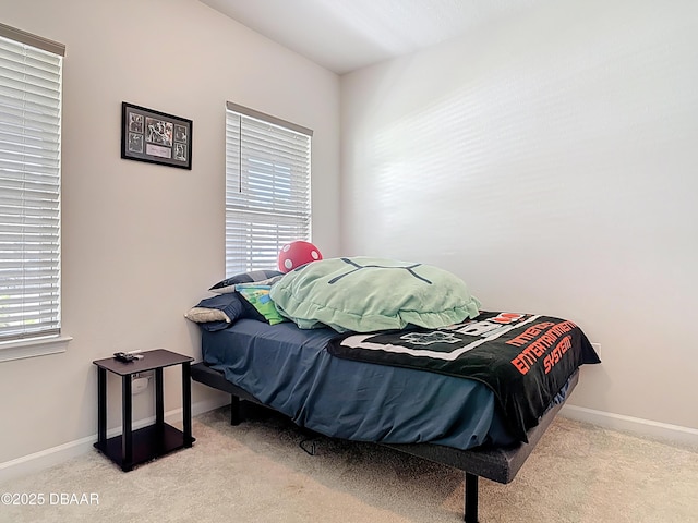 carpeted bedroom with multiple windows and baseboards