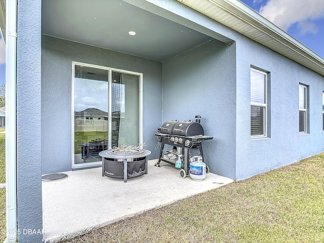 view of patio / terrace featuring area for grilling and a fire pit