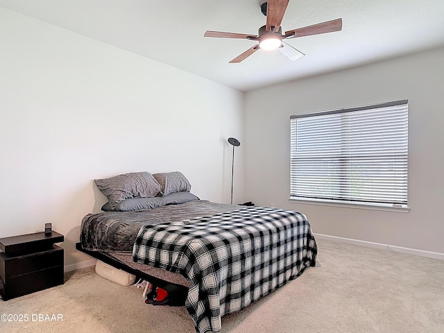 carpeted bedroom featuring baseboards and ceiling fan