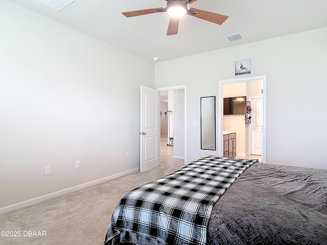 bedroom featuring ensuite bath, light colored carpet, visible vents, and baseboards