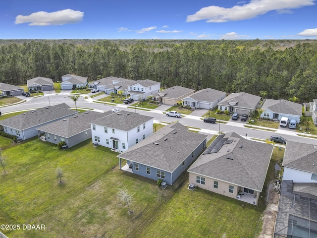 drone / aerial view with a view of trees and a residential view