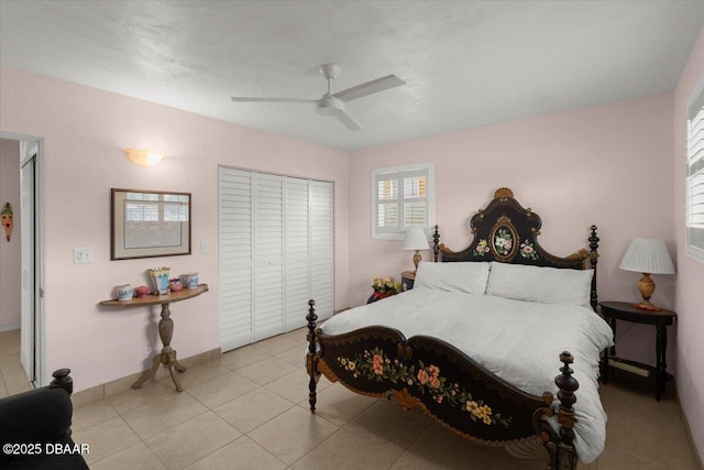 bedroom with ceiling fan, a closet, and light tile patterned flooring