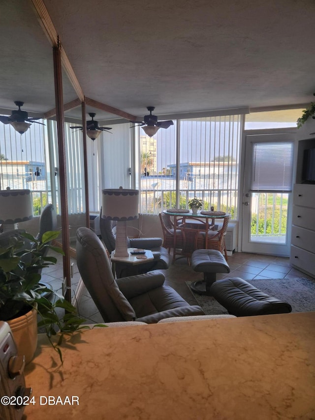 living room featuring light tile patterned floors and ceiling fan