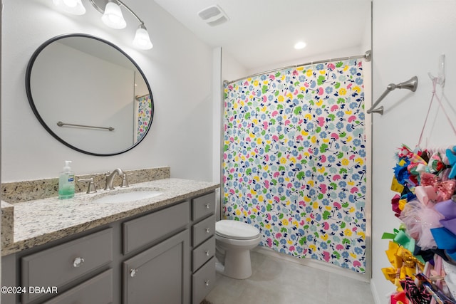 bathroom with toilet, vanity, and walk in shower