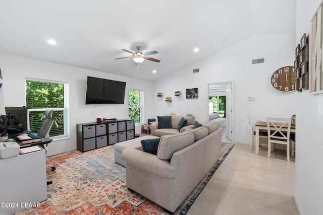 living room featuring light tile patterned floors, a healthy amount of sunlight, vaulted ceiling, and ceiling fan