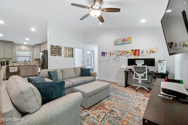 living room with ceiling fan, sink, and vaulted ceiling