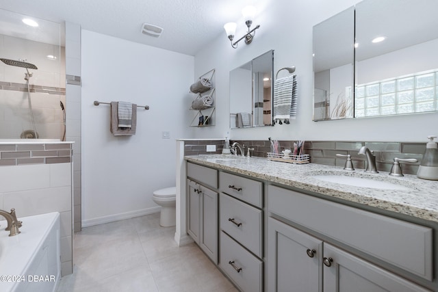 full bathroom with tile patterned floors, separate shower and tub, vanity, a textured ceiling, and toilet