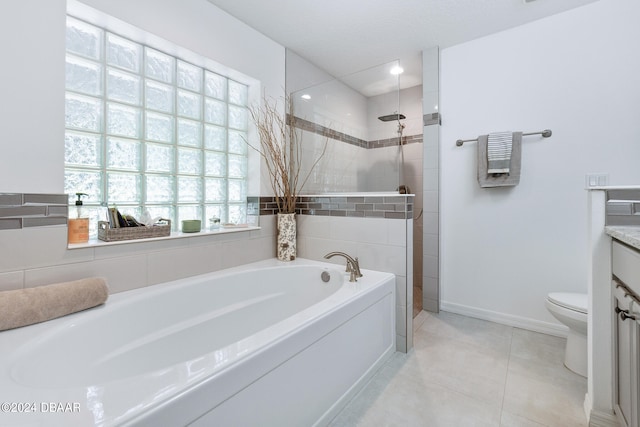 full bathroom featuring toilet, vanity, plus walk in shower, and tile patterned floors