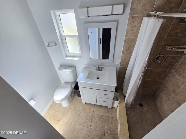 bathroom featuring a stall shower, baseboards, toilet, tile patterned flooring, and vanity