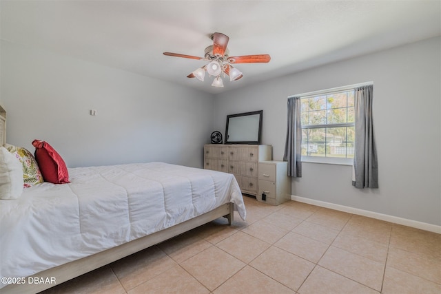 bedroom with light tile patterned floors, ceiling fan, and baseboards