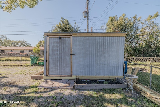 view of shed featuring a fenced backyard