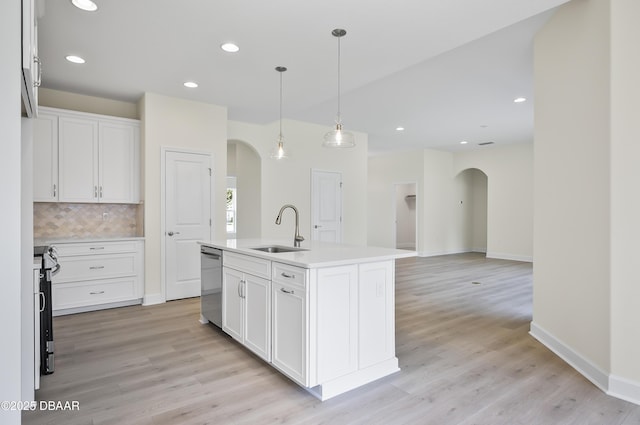 kitchen with sink, white cabinetry, a center island with sink, and stainless steel appliances