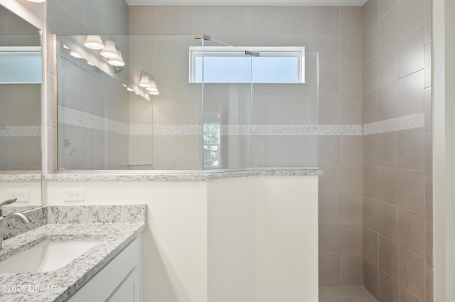 bathroom featuring vanity and a tile shower