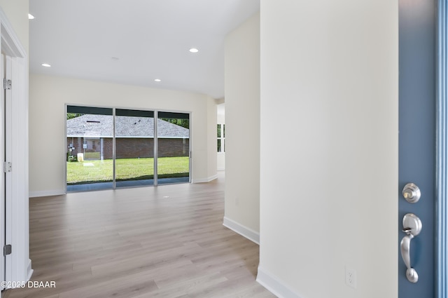 corridor with light hardwood / wood-style floors