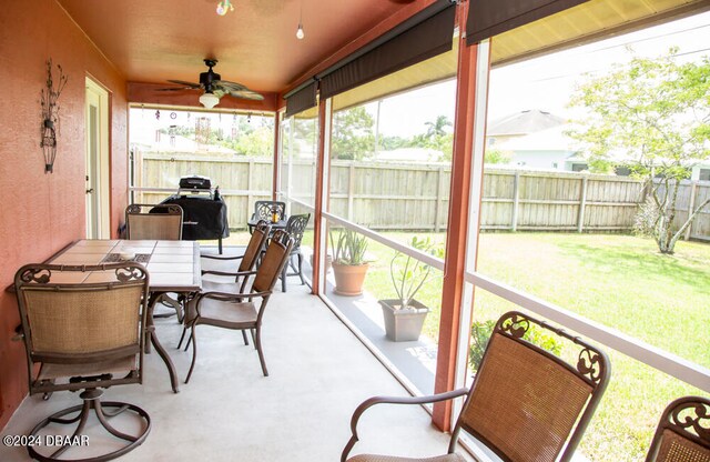 sunroom featuring ceiling fan