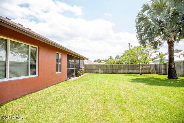 view of yard with a sunroom