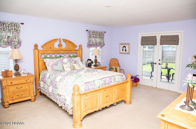 bedroom with light colored carpet, access to exterior, and french doors