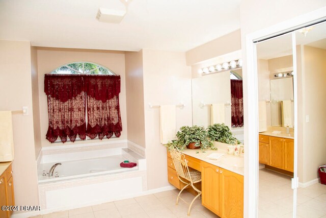 bathroom with vanity, a tub to relax in, and tile patterned floors