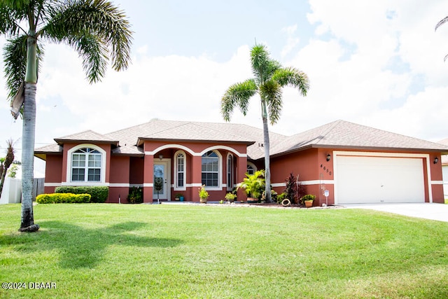 view of front of house with a front lawn and a garage