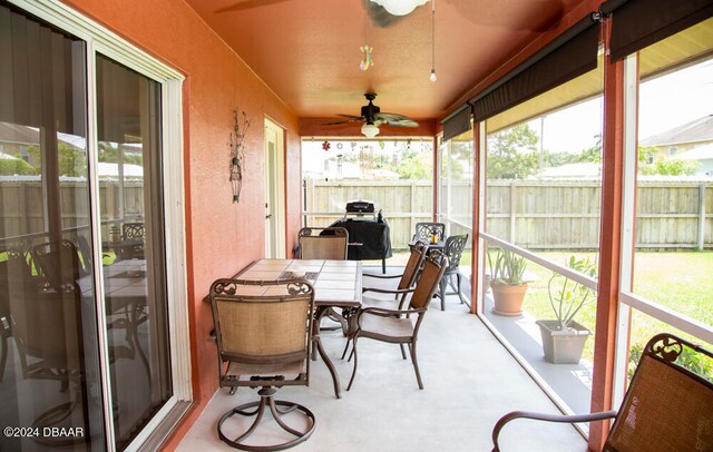 sunroom featuring ceiling fan