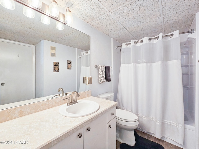 full bathroom featuring shower / tub combo, vanity, toilet, and hardwood / wood-style floors