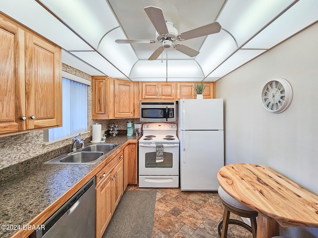 kitchen with backsplash, ceiling fan, sink, and stainless steel appliances