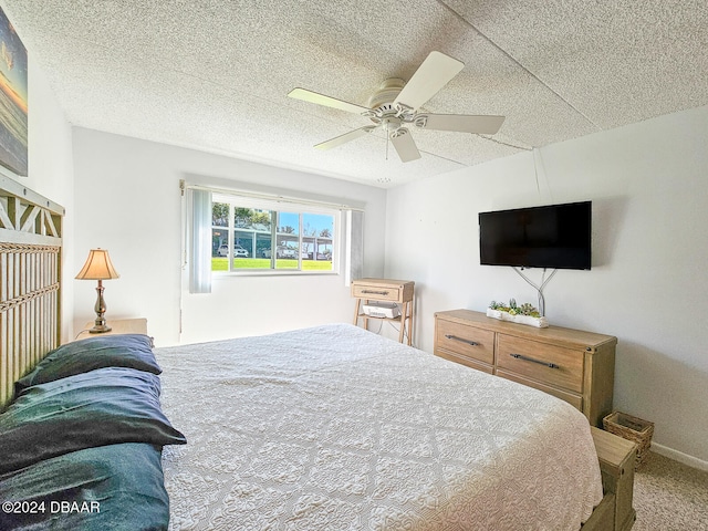 bedroom with carpet, ceiling fan, and a textured ceiling