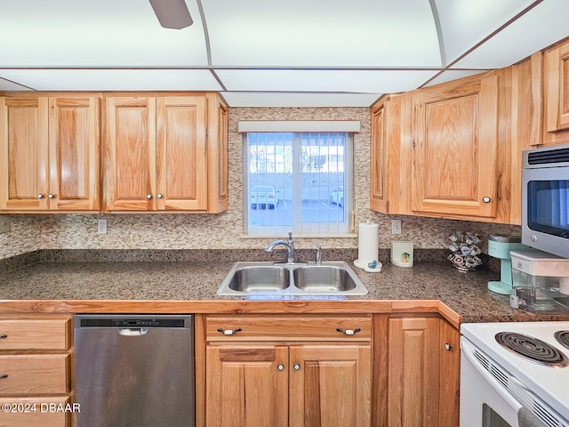 kitchen featuring a paneled ceiling, sink, appliances with stainless steel finishes, and tasteful backsplash