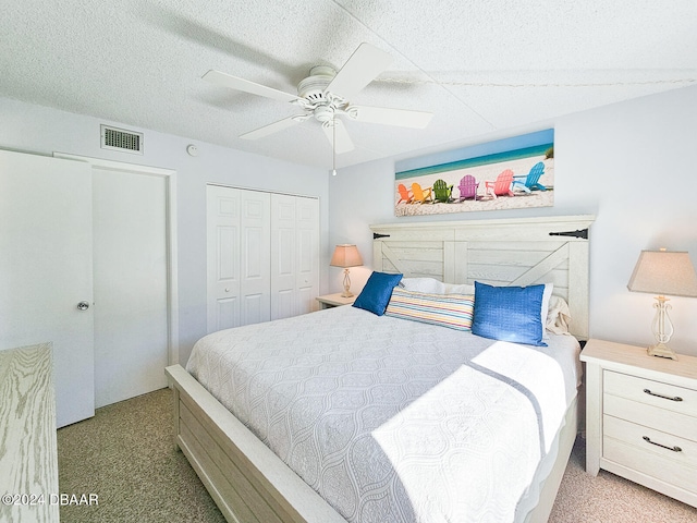 bedroom with ceiling fan, a closet, and light carpet